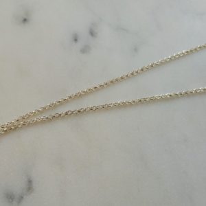 Silverfärgat halsband med en venussymbol i strass
