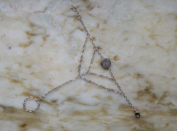 Antiksilverfärgat handsmycke med en druzyconnector i olika färger