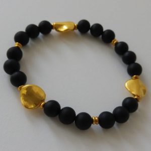 Elastiskt armband med guldfärgade asymmetriska mellandelar